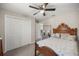Cozy bedroom with a ceiling fan and a decorative wooden bed frame at 22242 Sw Marine Blvd, Dunnellon, FL 34431