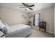 Comfortable bedroom features neutral walls, carpet, ceiling fan, and natural light from the large window at 22242 Sw Marine Blvd, Dunnellon, FL 34431