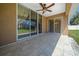 Covered back porch featuring tile flooring, ceiling fan, and sliding glass doors to backyard at 2301 Se 24Th Ave, Ocala, FL 34471