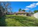 Large, grassy backyard with mature trees and wooden fencing creates a private outdoor space at 2301 Se 24Th Ave, Ocala, FL 34471