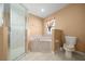 Bathroom featuring stand-up shower, jetted tub, and toilet at 2301 Se 24Th Ave, Ocala, FL 34471