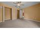 Neutral carpet, ceiling fan, and convenient closets enhance the appeal of this comfortable bedroom at 2301 Se 24Th Ave, Ocala, FL 34471