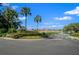 The community entrance boasts lush landscaping, palm trees, and well-maintained grounds at 2301 Se 24Th Ave, Ocala, FL 34471