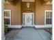 Elegant front door with decorative glass, framed by white pillars, and a covered entrance at 2301 Se 24Th Ave, Ocala, FL 34471