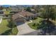 Aerial view of a well-maintained single-Gathering home with mature landscaping and a paved driveway at 2301 Se 24Th Ave, Ocala, FL 34471