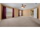 Bright living room featuring neutral walls, carpet, ceiling fan, and an abundance of natural light at 2301 Se 24Th Ave, Ocala, FL 34471