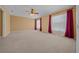 Large main bedroom featuring carpeted flooring, ceiling fan, and ample natural light at 2301 Se 24Th Ave, Ocala, FL 34471