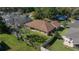 Aerial view of the home's backyard, featuring green lawn, trees, and a fenced perimeter at 2301 Se 24Th Ave, Ocala, FL 34471