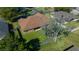 Aerial view of a home's backyard featuring green lawn, mature trees, and wooden privacy fence at 2301 Se 24Th Ave, Ocala, FL 34471