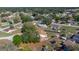 An aerial view shows houses interspersed with trees at 328 Oak Track Run, Ocala, FL 34472