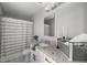 Elegant bathroom featuring a granite countertop vanity, patterned shower curtain, and a decorative mirror at 328 Oak Track Run, Ocala, FL 34472