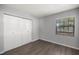 Cozy bedroom with wood-look floors, natural light, and a closet at 328 Oak Track Run, Ocala, FL 34472