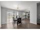 Cozy dining area with stylish table, elegant chandelier, and sliding glass doors to the backyard at 328 Oak Track Run, Ocala, FL 34472