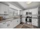 Bright kitchen with granite countertops, white cabinets, stainless steel appliances, and modern backsplash at 328 Oak Track Run, Ocala, FL 34472