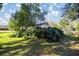 View of the backyard with lush greenery, offering a private and serene outdoor space at 3301 Se 32Nd Ave, Ocala, FL 34471