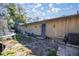 Exterior shot of the backyard and rear door of the home and a peek at the surrounding landscape at 3301 Se 32Nd Ave, Ocala, FL 34471