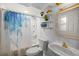 Bathroom featuring a white vanity, flower-printed shower curtain, and decorative shelves at 3301 Se 32Nd Ave, Ocala, FL 34471