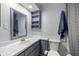 Updated bathroom with a built-in shelf, framed mirror, and shower and tub combo at 3301 Se 32Nd Ave, Ocala, FL 34471