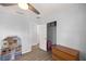 Bedroom with neutral walls, ceiling fan, closet, and light-colored wood-look flooring at 3301 Se 32Nd Ave, Ocala, FL 34471