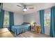 Bright bedroom with wood-look flooring, ceiling fan, and large windows at 3301 Se 32Nd Ave, Ocala, FL 34471