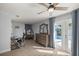 Bright main bedroom featuring an adjacent workspace, pool access, and wood-look flooring at 3301 Se 32Nd Ave, Ocala, FL 34471