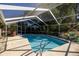 The in-ground screened pool features concrete tile and a relaxing view of the surrounding landscape at 3301 Se 32Nd Ave, Ocala, FL 34471