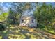 Exterior of storage shed nestled in a shady area of the yard and surrounded by foliage at 3301 Se 32Nd Ave, Ocala, FL 34471