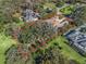 Aerial view of the home and its landscaped lot with mature trees, showcasing its privacy at 3848 Nw 85Th Ter, Ocala, FL 34482