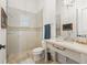 Bright bathroom featuring a glass enclosed shower, vanity sink with marble countertop and decorative tile accents at 3848 Nw 85Th Ter, Ocala, FL 34482