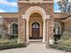 Elegant stone facade with arched entrance, decorative columns and meticulously landscaped surroundings at 3848 Nw 85Th Ter, Ocala, FL 34482