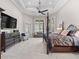 Spacious main bedroom featuring a tray ceiling, bay windows and an elegant four poster bed at 3848 Nw 85Th Ter, Ocala, FL 34482