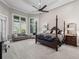 Spacious main bedroom featuring tray ceilings, windows and an elegant four-poster bed at 3848 Nw 85Th Ter, Ocala, FL 34482