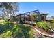 Fenced backyard featuring a covered outdoor pool, manicured lawn and landscaped perimeter, perfect for outdoor enjoyment at 4103 Se 10Th Ave, Ocala, FL 34480