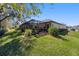 Backyard featuring a covered outdoor pool, landscaped greenery, a manicured lawn and a fenced perimeter at 4103 Se 10Th Ave, Ocala, FL 34480