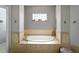 Bathroom showcasing a soaking tub with tiled surround and niche window at 4103 Se 10Th Ave, Ocala, FL 34480