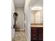 Hallway view into bathroom with granite counters, dark wood cabinets, and neutral paint at 4103 Se 10Th Ave, Ocala, FL 34480