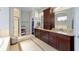Expansive bathroom with dual vanities, granite countertops, and a separate walk-in shower at 4103 Se 10Th Ave, Ocala, FL 34480