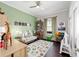 Playful bedroom with bright green walls, whimsical decor, and a cozy daybed for reading and relaxation at 4103 Se 10Th Ave, Ocala, FL 34480