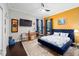 Elegant bedroom featuring a plush blue bed, stylish decor, and ample natural light from the windows at 4103 Se 10Th Ave, Ocala, FL 34480