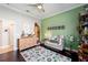 Bright bedroom with olive green walls, playful decor, and a cozy daybed for reading and relaxation at 4103 Se 10Th Ave, Ocala, FL 34480