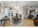 Bright breakfast nook featuring a charming round table, elegant chandelier, and views of the outdoors at 4103 Se 10Th Ave, Ocala, FL 34480