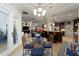 Dining area with view of living room and kitchen, tray ceiling, and designer chandelier at 4103 Se 10Th Ave, Ocala, FL 34480