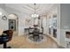 Inviting dining area with a round table, chandelier, and large windows at 4103 Se 10Th Ave, Ocala, FL 34480