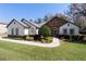 Charming single-story home with stone accents, manicured lawn, and inviting walkway at 4103 Se 10Th Ave, Ocala, FL 34480