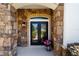 Charming front porch with stone accents, a decorative plant, and an inviting black front door at 4103 Se 10Th Ave, Ocala, FL 34480