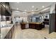 Spacious kitchen featuring stainless steel appliances, dark wood cabinets, granite countertops and open floor plan at 4103 Se 10Th Ave, Ocala, FL 34480