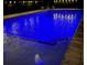 This lovely in-ground pool is lit up with blue underwater lights at night, creating a relaxing oasis at 4103 Se 10Th Ave, Ocala, FL 34480