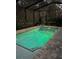 In-ground pool with underwater lighting and string lights creating a charming oasis for relaxation and evening swims at 4103 Se 10Th Ave, Ocala, FL 34480