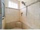 Tiled walk-in shower featuring dual shower heads, a built-in niche, and a window at 4103 Se 10Th Ave, Ocala, FL 34480