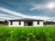 A view of the home's rear exterior and lawn, with bright sky overhead at 4524 Sw 110Th St, Ocala, FL 34476